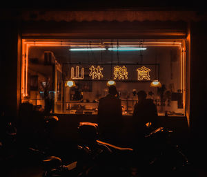 Rear view of people in restaurant at night