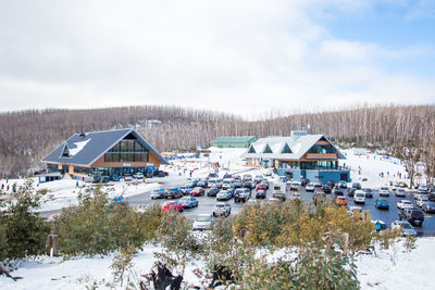 Houses on field against sky during winter