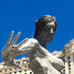 Low angle view of statue against clear blue sky