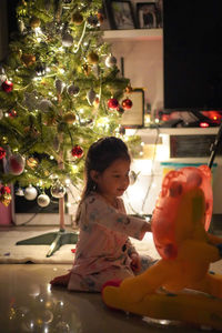 Girl with christmas tree at home