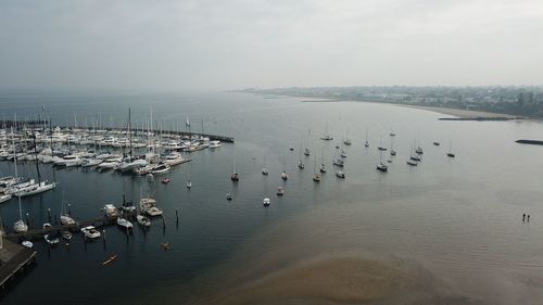 High angle view of boats moored in sea against sky