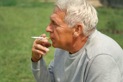 Young man smoking cigarette