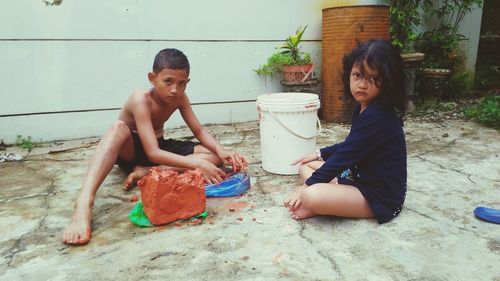 Mother and girl sitting outdoors