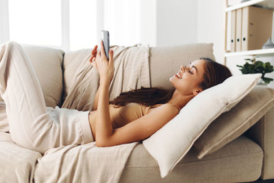 Young woman sleeping on bed at home