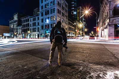 Rear view of a man standing in city street