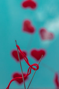 Close-up of heart shape on table against blue background