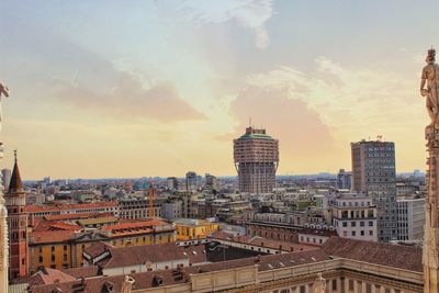 High angle view of buildings against cloudy sky