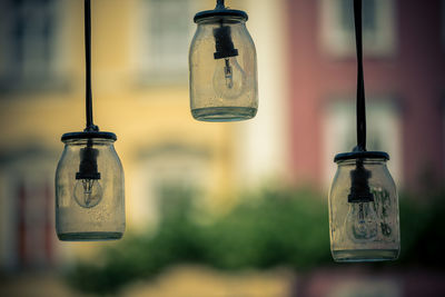 Close-up of light bulbs hanging on glass