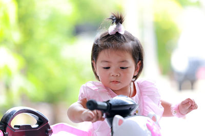 Portrait of cute girl with pink petals