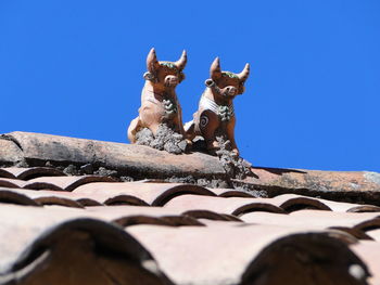 Low angle view of built structure against clear blue sky