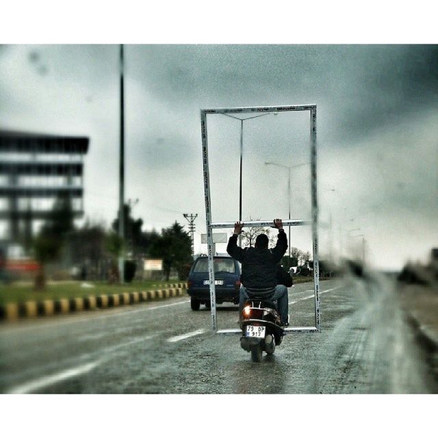 transportation, mode of transport, land vehicle, road, car, street, on the move, men, road marking, travel, glass - material, transfer print, sky, rear view, day, auto post production filter, transparent, city