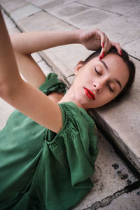 High angle portrait of woman lying on floor