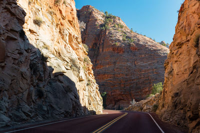 Road leading towards rocky mountains