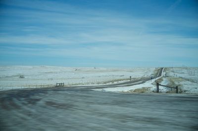 Scenic view of snow covered landscape against blue sky