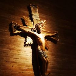 Low angle view of angel statue against wall