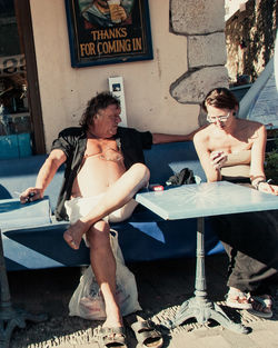 Full length of a young woman sitting outdoors