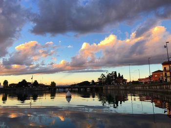 Scenic view of river against sky at sunset