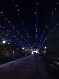 Illuminated christmas lights in city at night