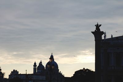 Silhouette of building against sky during sunset