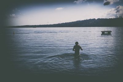 Silhouette of man in sea