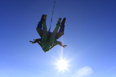 Low angle view of woman jumping