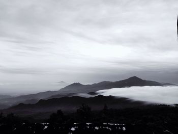 Scenic view of mountains against cloudy sky