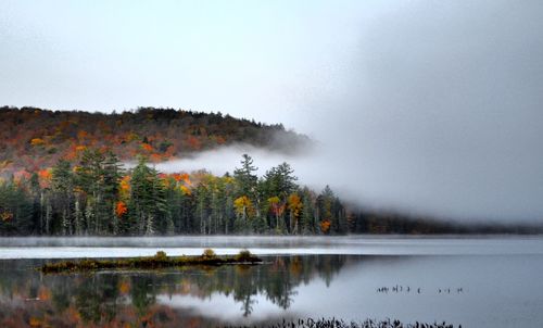 Scenic view of lake against sky during autumn