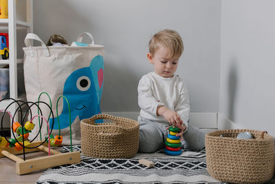 Cute boy playing with toy at home