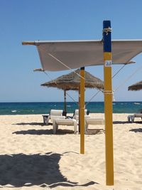 Lifeguard hut on beach against clear sky