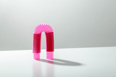 High angle view of pink umbrella on table against white background