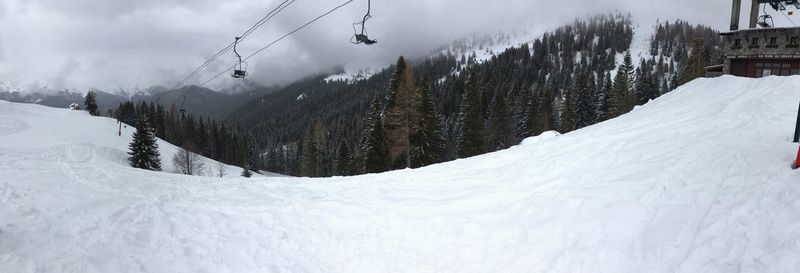 Overhead cable car against sky during winter