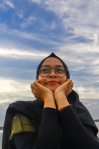 Close-up of woman standing against sky