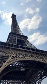 Low angle view of tower against cloudy sky