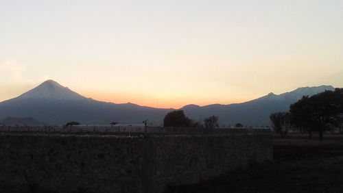 Scenic view of field against sky during sunset