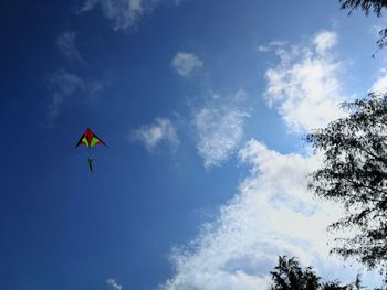 Low angle view of kite flying against blue sky