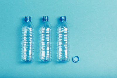 Close-up of plastic bottle on table against blue background