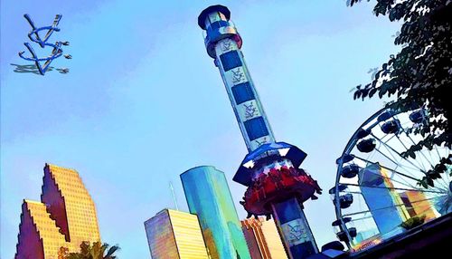 Low angle view of amusement park against sky