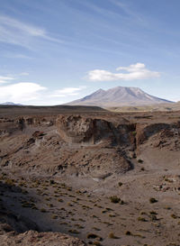 Scenic view of arid landscape against sky