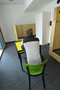 Rear view of woman sitting on chair