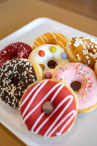 High angle view of various donut desserts on a table