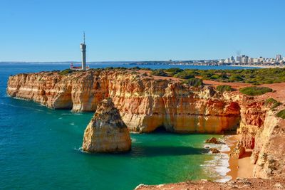 Panoramic view of sea and buildings against sky