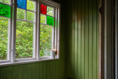 Plants seen through window of house