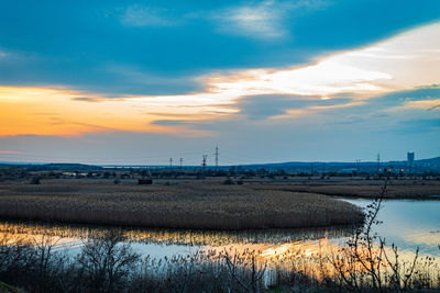 Scenic view of lake against sky during sunset