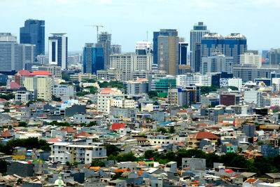 High angle view of buildings in city against sky