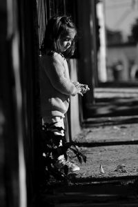 Side view of girl standing on footpath