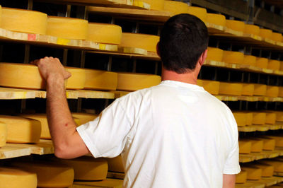 Rear view of man working at store