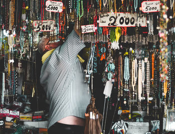 Rear view of woman standing in store