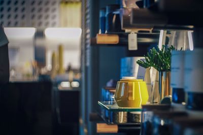 Yellow teapot on glass counter at cafe