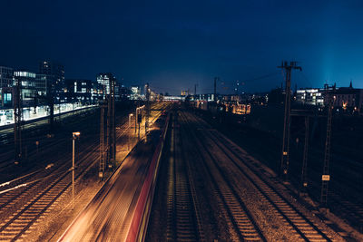 High angle view of railway tracks against sky at night