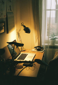 Electric lamp on table by window at home